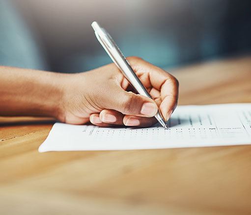 Someone writing on a paper